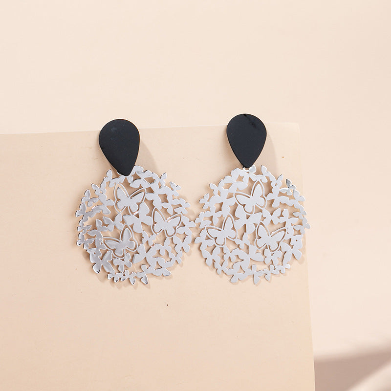 Pendientes de metal de color de mariposa hueca de contraste al por mayor